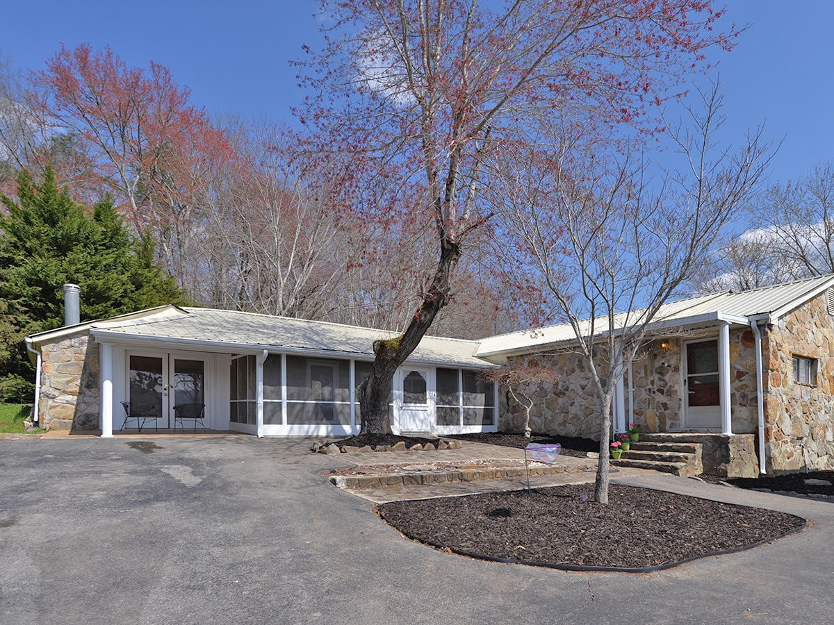 1743 Fairview Road Oliver Springs, TN 37840 - Photo 1 of 19 a front view of a house with garden