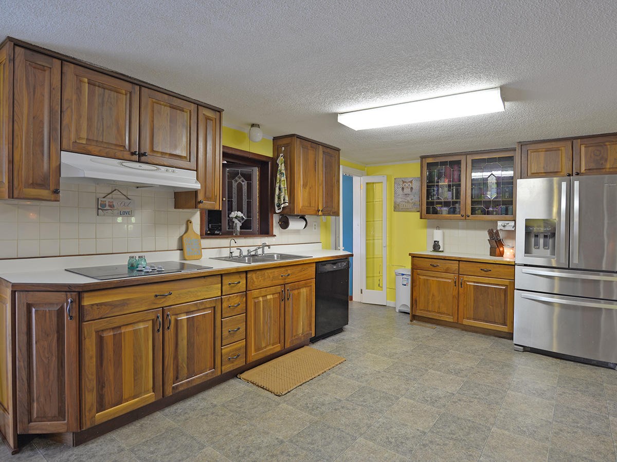 1743 Fairview Road Oliver Springs, TN 37840 - Photo 8 of 19 a kitchen with stainless steel appliances granite countertop a refrigerator sink and cabinets