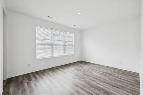 a kitchen with stainless steel appliances granite countertop a dining table chairs stove a sink and dishwasher