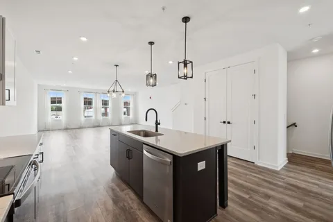 a living room with furniture and kitchen view