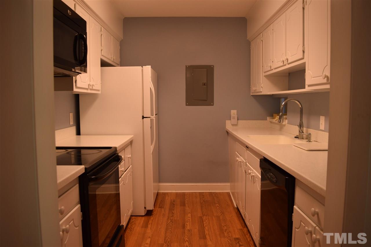4519 Edwards Mill Road, Unit F Raleigh, NC 27612 - Photo 4 of 14 a kitchen with a sink a refrigerator and a stove