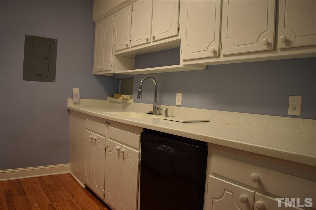 4519 Edwards Mill Road, Unit F Raleigh, NC 27612 - Photo 6 of 14 a kitchen with a sink cabinets and a wooden floor