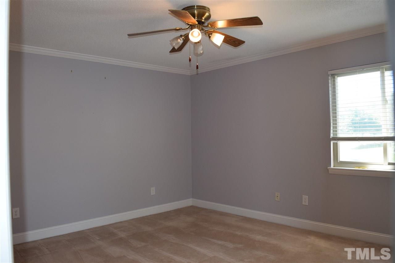 4519 Edwards Mill Road, Unit F Raleigh, NC 27612 - Photo 8 of 14 an empty room with a window and a fan