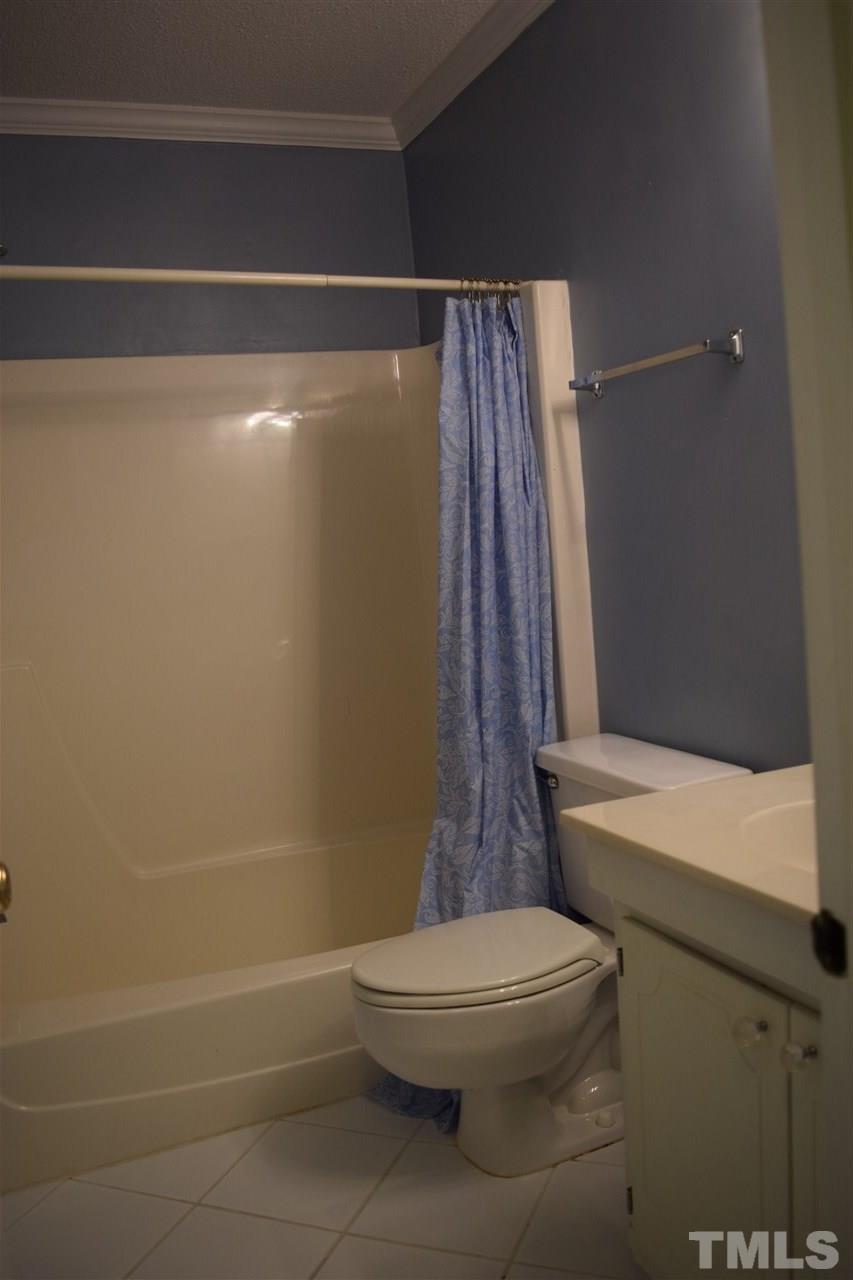 4519 Edwards Mill Road, Unit F Raleigh, NC 27612 - Photo 10 of 14 a bathroom with a toilet and a shower