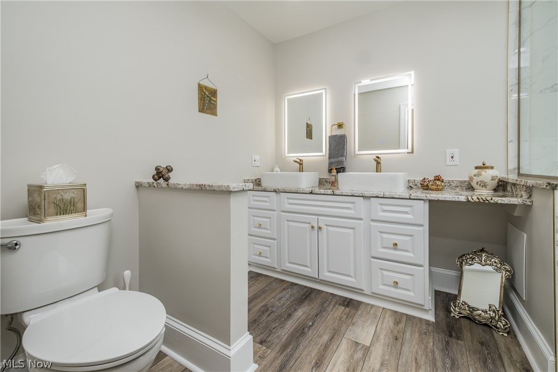 1415 Harbor Drive Northwest Canton, OH 44708 - Photo 28 of 46 Owners Bathroom featuring wood-type flooring, vanity, granite counters and toilet
