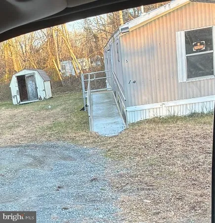 a view of a backyard with wooden fence
