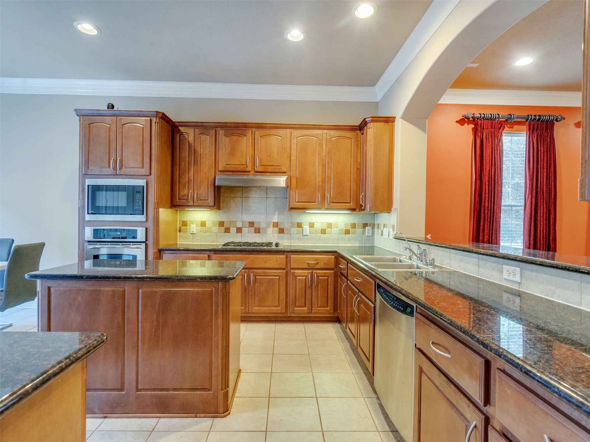 1502 Olive Place Houston, TX 77077 - Photo 13 of 35 a kitchen with a sink window and cabinets