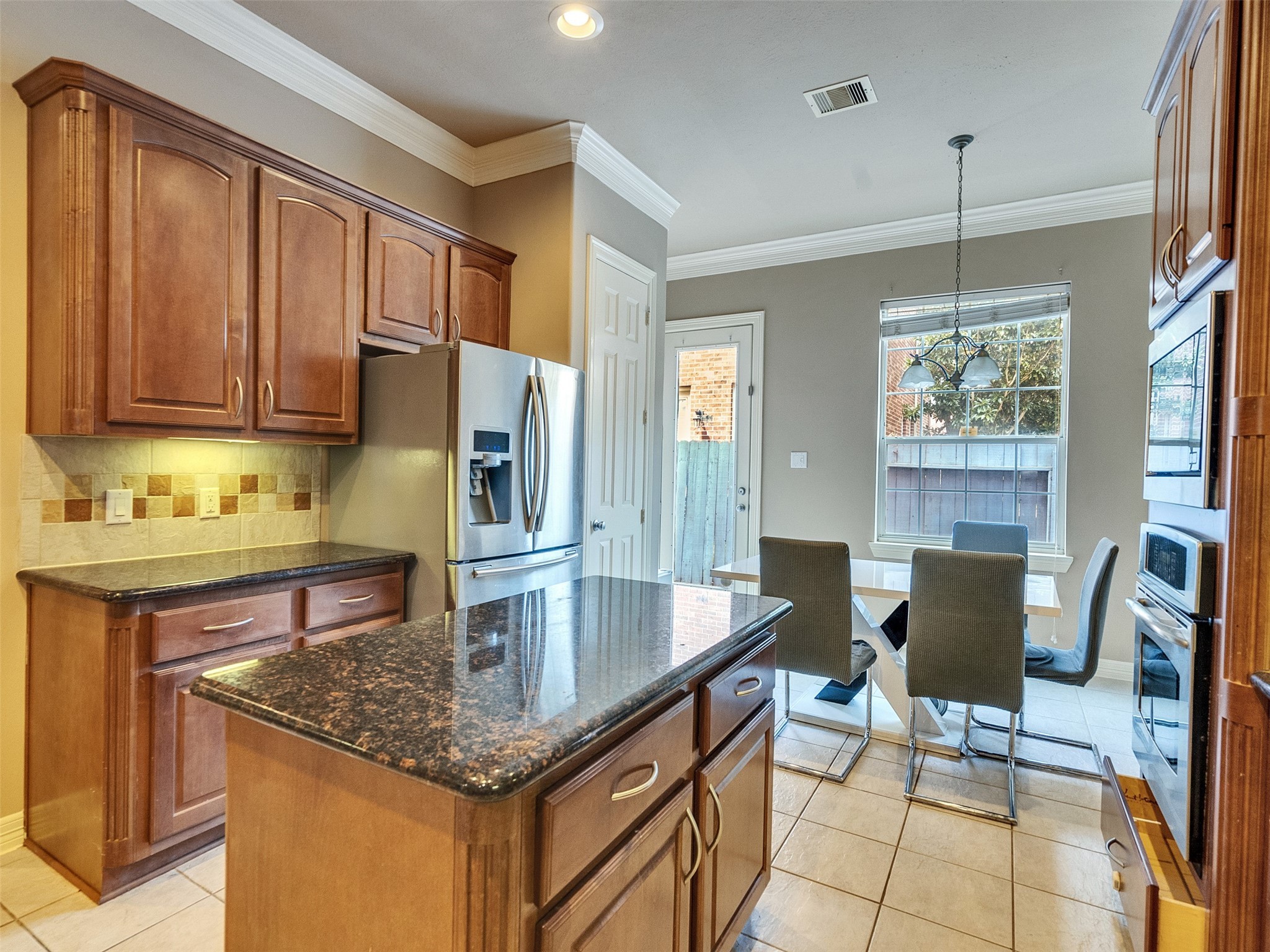 1502 Olive Place Houston, TX 77077 - Photo 15 of 35 a kitchen with granite countertop a counter space dining table and stainless steel appliances