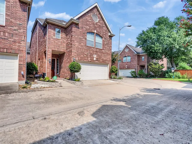 front view of a brick house with a street