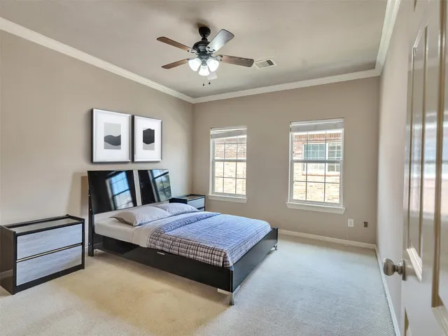 a spacious bedroom with a bed next to a window