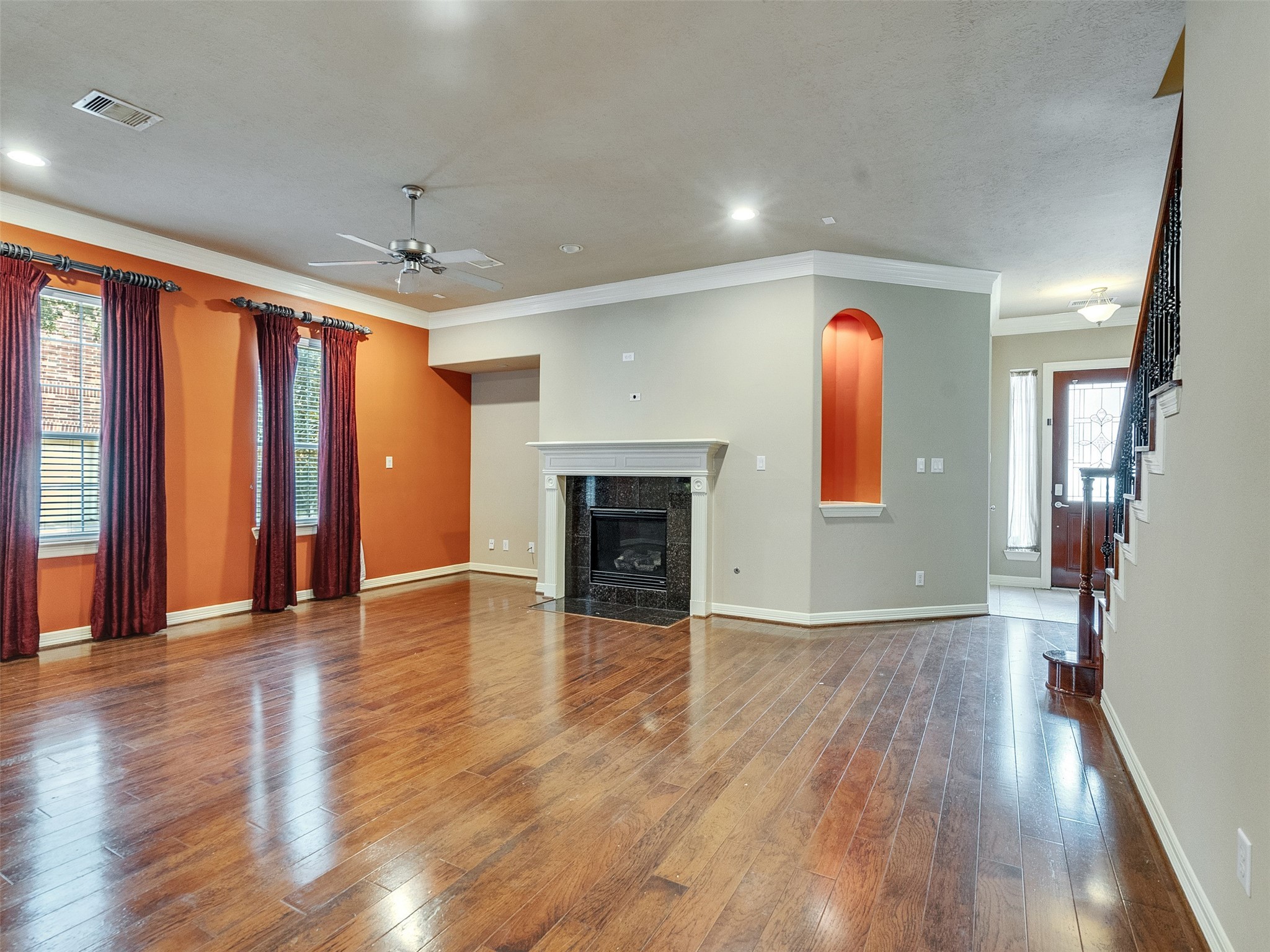 1502 Olive Place Houston, TX 77077 - Photo 7 of 35 an empty room with wooden floor and a fireplace