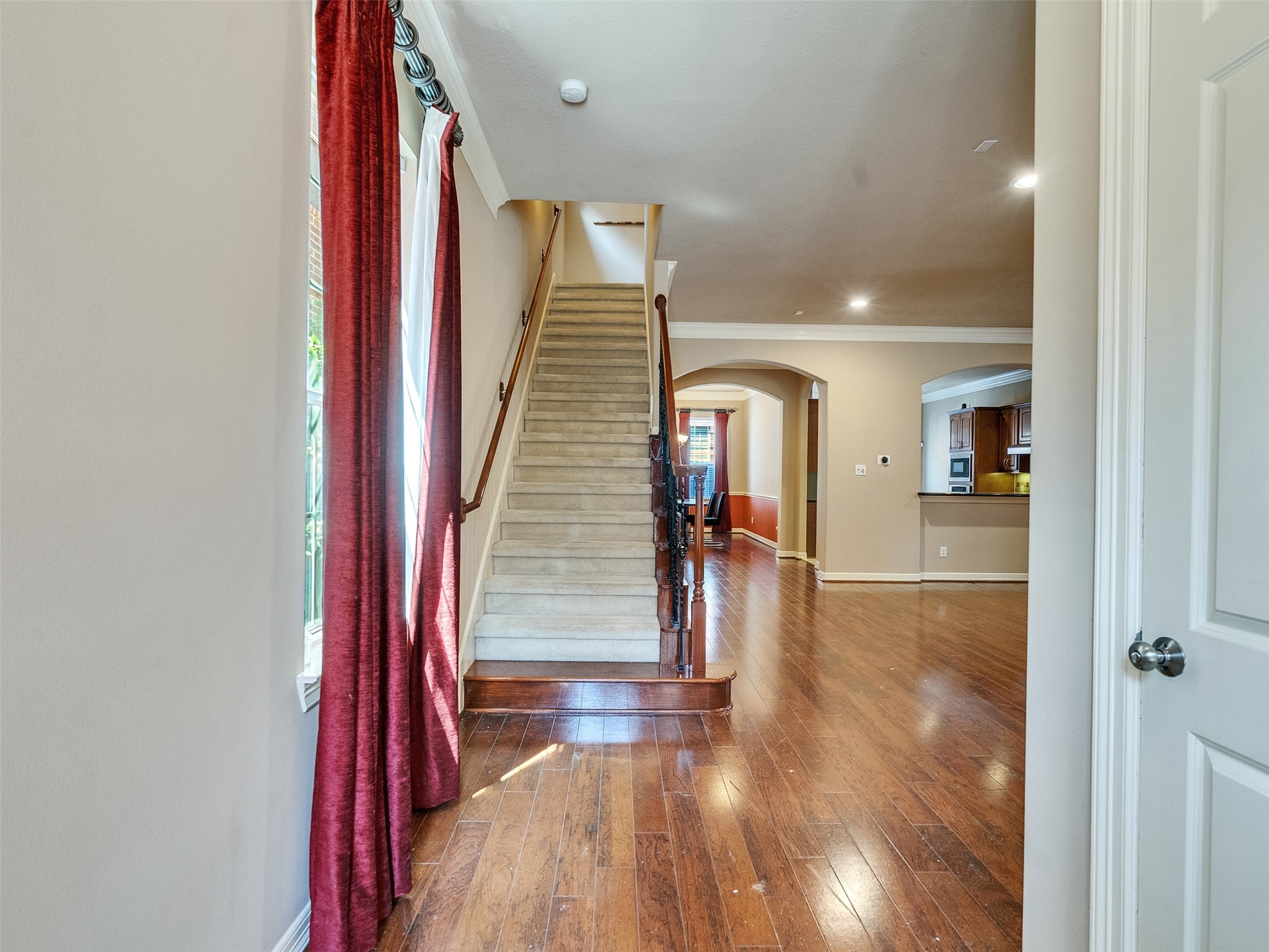 1502 Olive Place Houston, TX 77077 - Photo 9 of 35 a view of a hallway with wooden floor and staircase