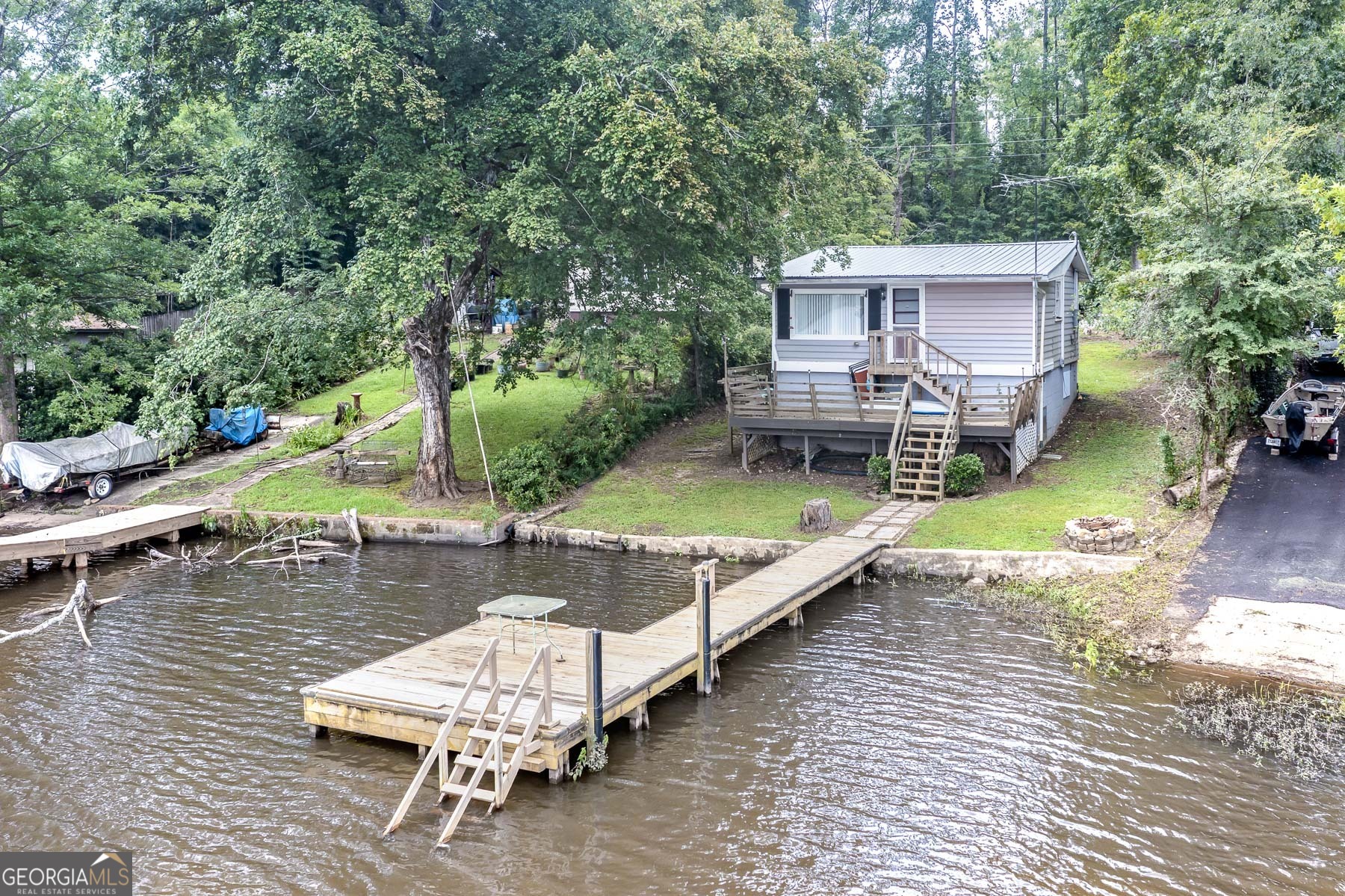 an aerial view of a house with swimming pool and porch