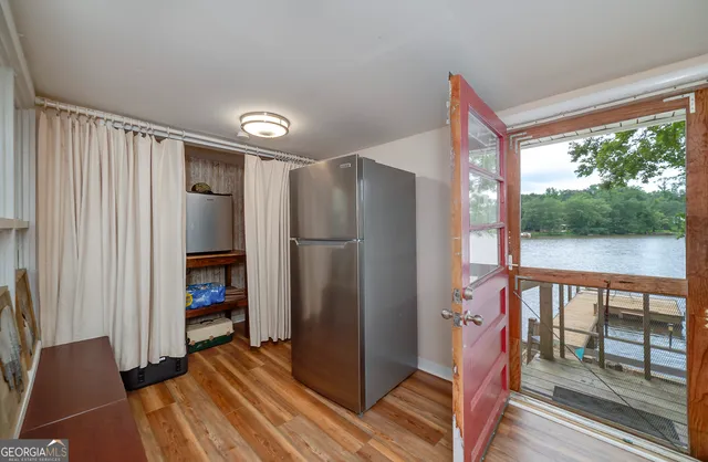 a view of a hallway with wooden floor and entryway