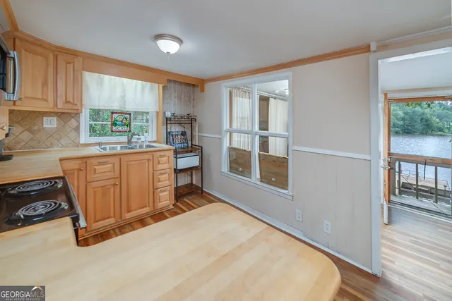 a kitchen with a stove a refrigerator and wooden cabinets