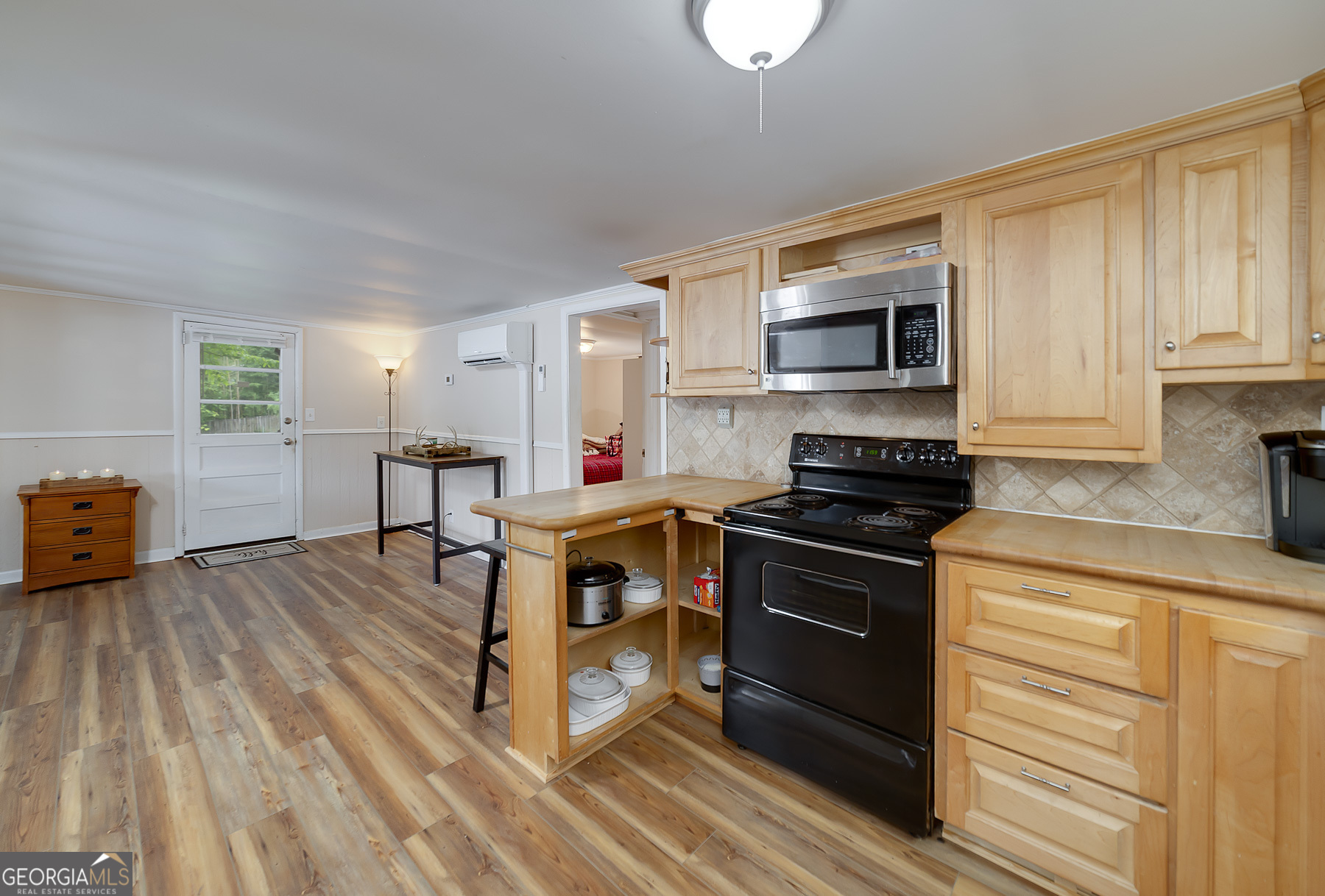 126 Elizabeth Circle Jackson, GA 30233 - Photo 23 of 33 a kitchen with stainless steel appliances a stove a sink dishwasher and a microwave oven with cabinets