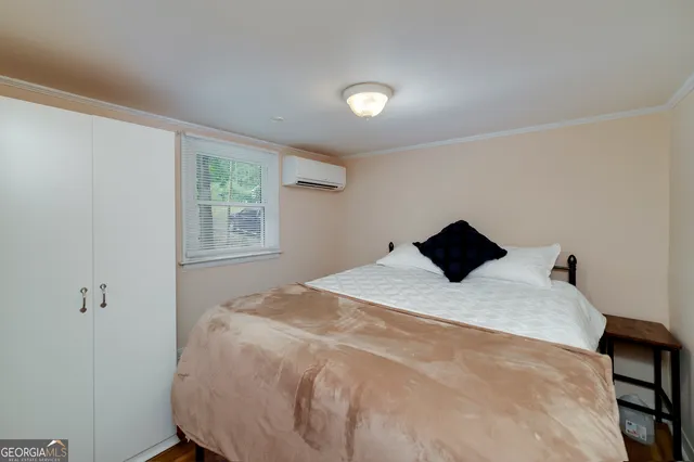 a bedroom with a bed and a window