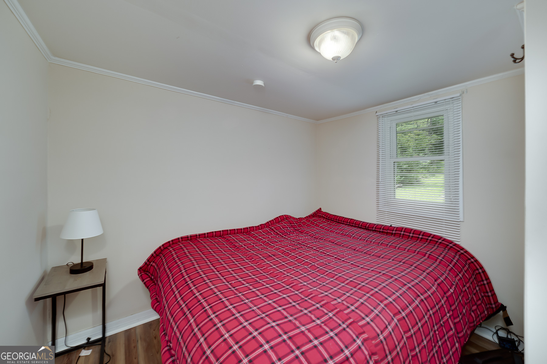126 Elizabeth Circle Jackson, GA 30233 - Photo 26 of 33 a bedroom with a bed and a lamp next to a window