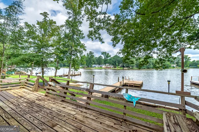 a view of a lake with wooden deck and lake view