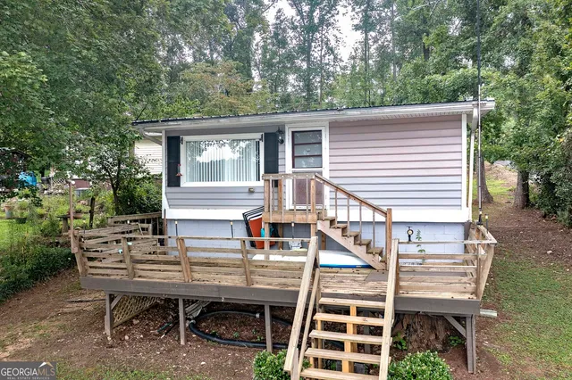a view of a chairs and table in the back yard