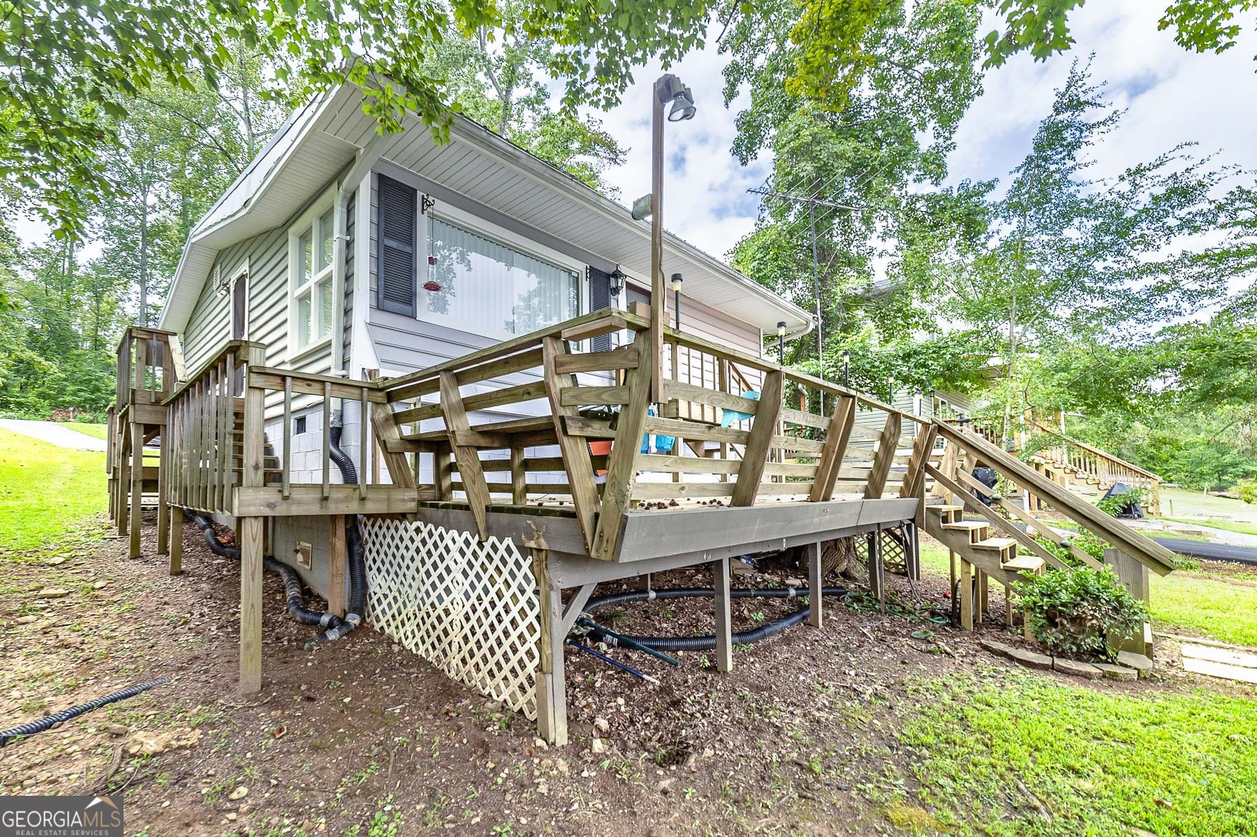 126 Elizabeth Circle Jackson, GA 30233 - Photo 31 of 33 a view of a chairs setting on the deck in front of a house