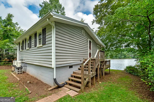 a view of house with backyard and outdoor seating