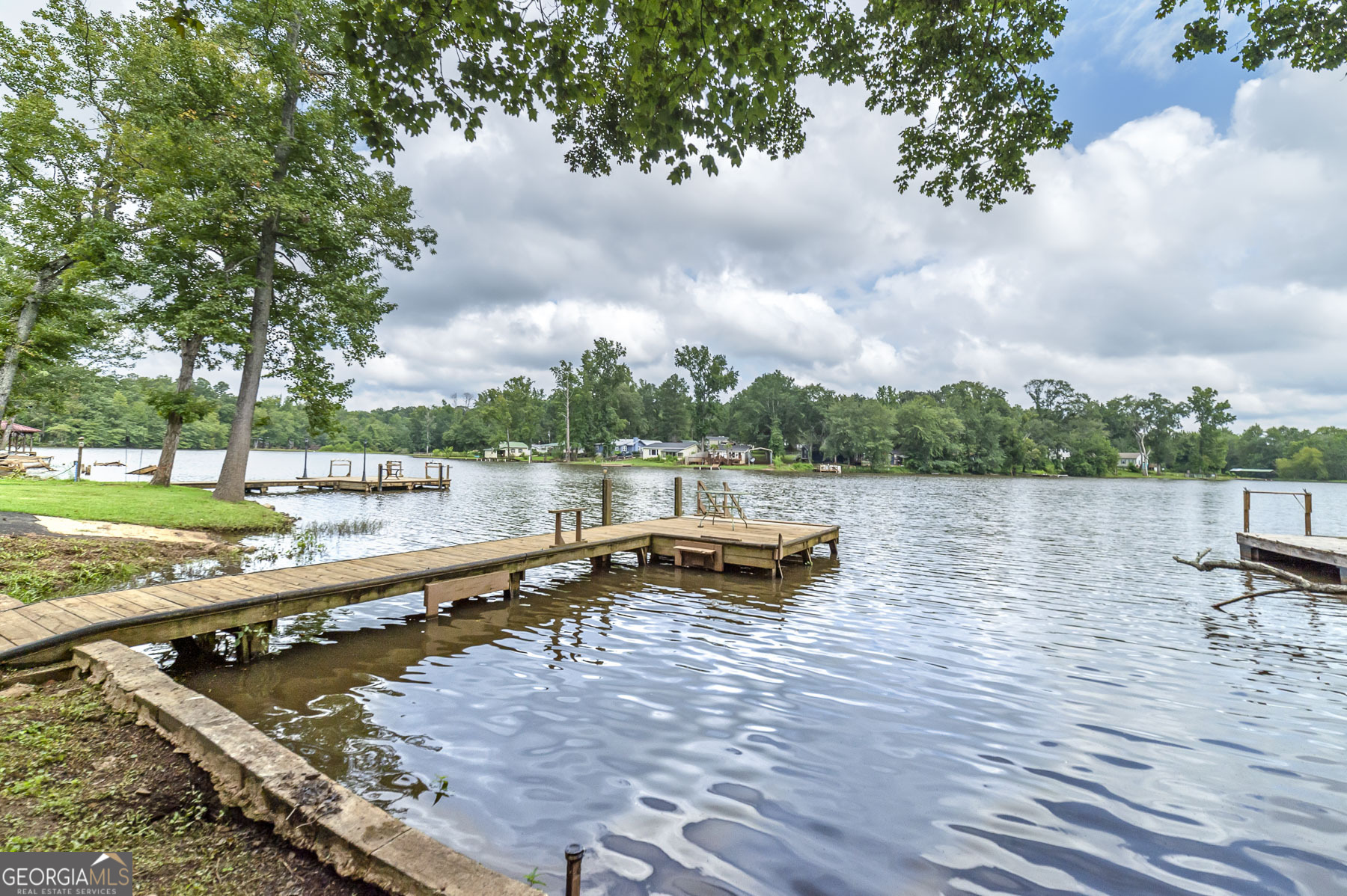 126 Elizabeth Circle Jackson, GA 30233 - Photo 9 of 33 a backyard of a house with lots of green space and lake view