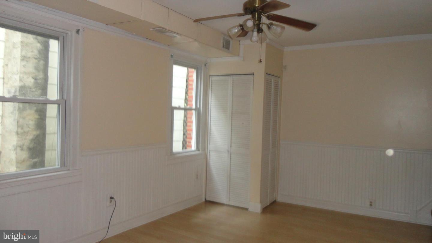 309 West Avenue Pitman, NJ 08071 - Photo 4 of 12 a view of empty room with a window and chandelier fan