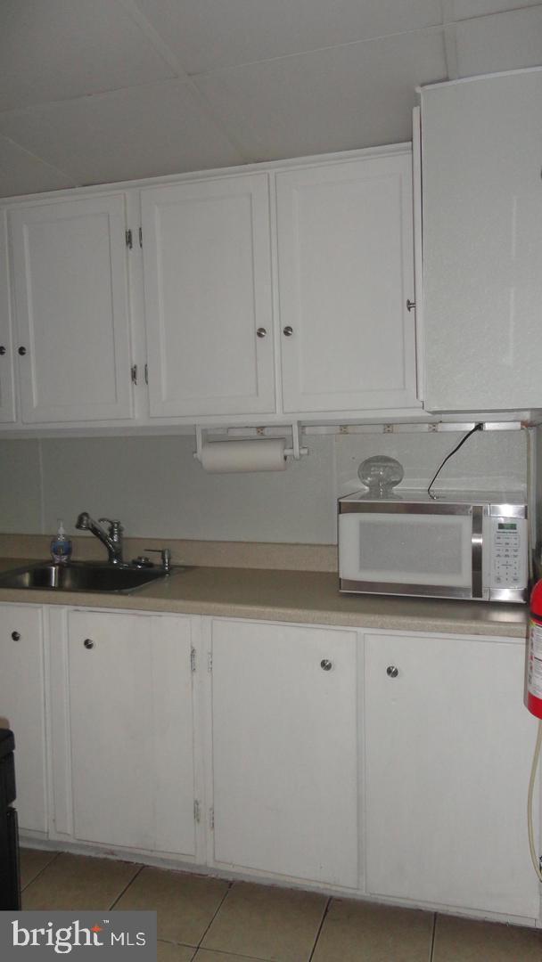 309 West Avenue Pitman, NJ 08071 - Photo 7 of 12 a kitchen with granite countertop white cabinets and sink