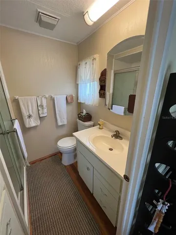 a bathroom with a double vanity sink mirror and toilet