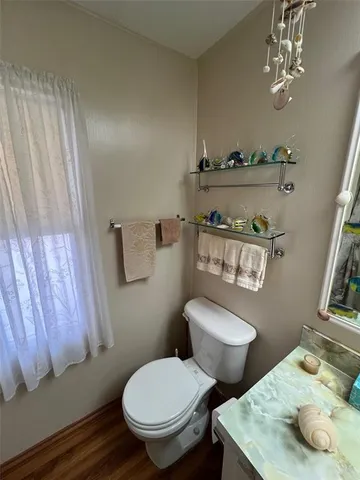 a white toilet sitting next to a bathroom sink and vanity