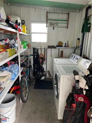 a utility room with dryer washer and other items