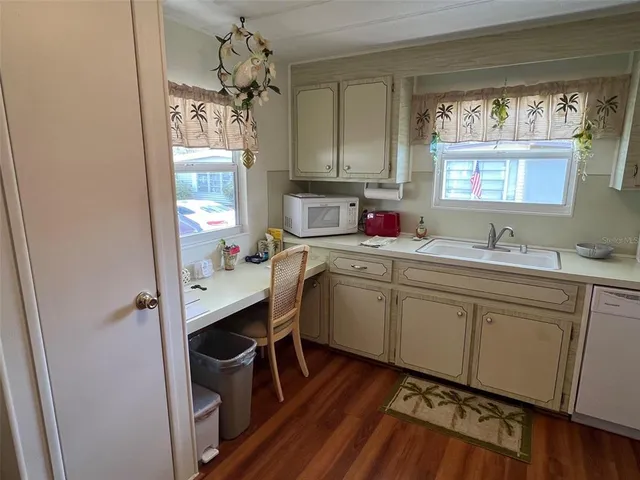 a kitchen with a sink cabinets and window