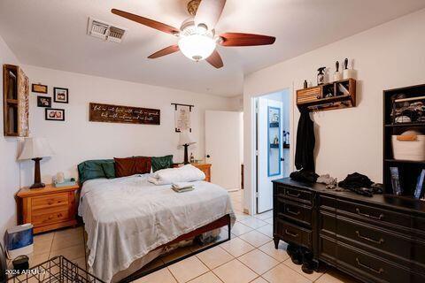 12517 West Bloomfield Road El Mirage, AZ 85335 - Photo 7 of 16 a bedroom with a bed and a chandelier