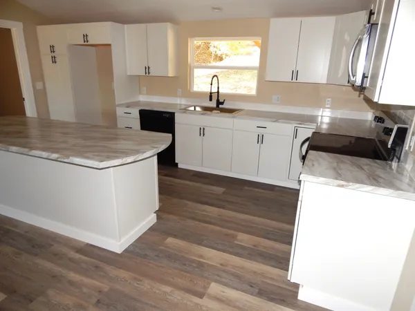 a kitchen with a sink stove and cabinets
