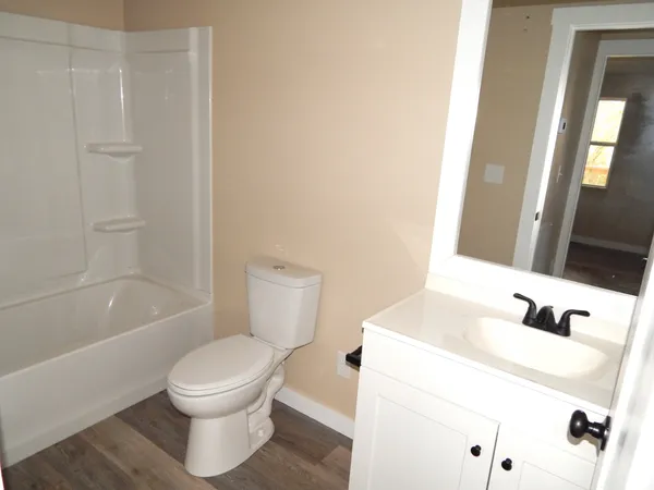 a white toilet sitting next to a bathroom sink