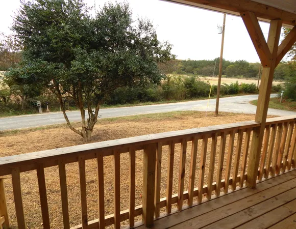 a view of a balcony with yard