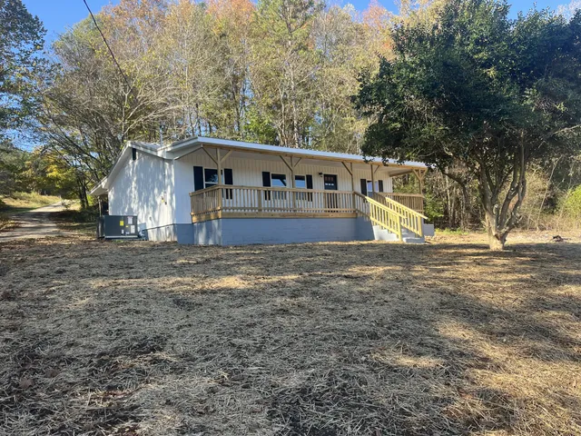 a house that has a tree in front of it