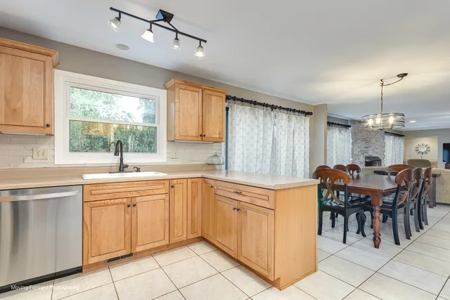 a kitchen with kitchen island granite countertop a sink table and chairs
