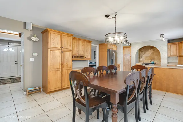 a view of a a dining room with furniture window and wooden floor