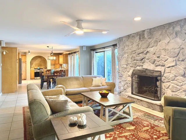 a living room with furniture and a fireplace