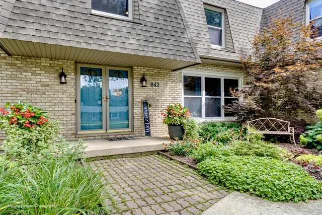 front view of a brick house with a large window