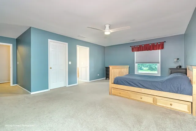 a bedroom with a bed and a dresser in it