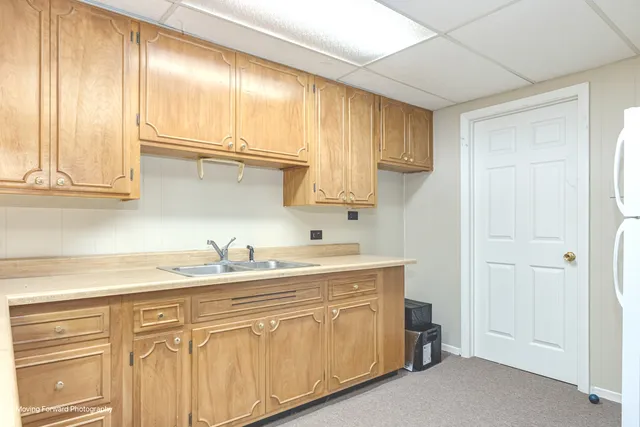 a kitchen with stainless steel appliances granite countertop a sink and cabinets with wooden floor