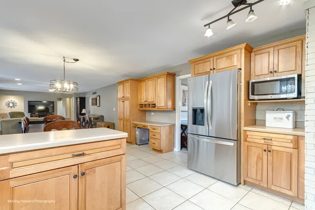 a kitchen with a refrigerator and microwave