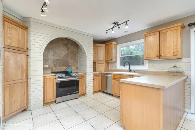 a kitchen with a stove a sink and a refrigerator