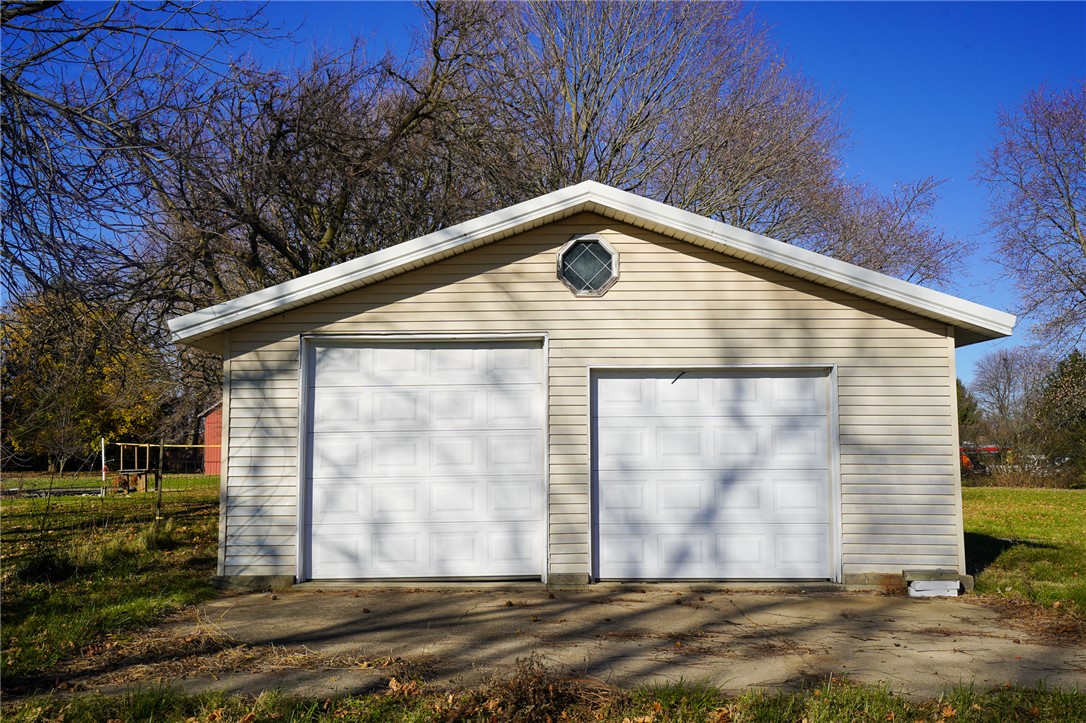 8746 Grubbs-Rex Road Arcanum, OH 45304 - Photo 31 of 38 This functional two-car garage offers ample parking and storage, featuring durable siding and a clear sky.