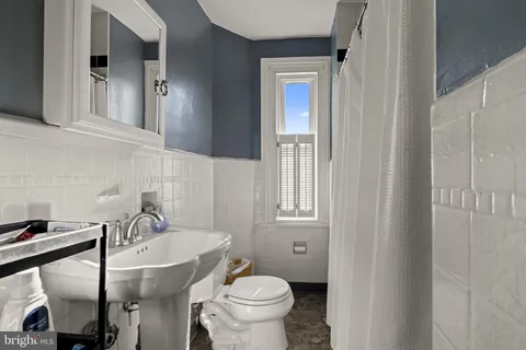 a bathroom with a sink a toilet and tub