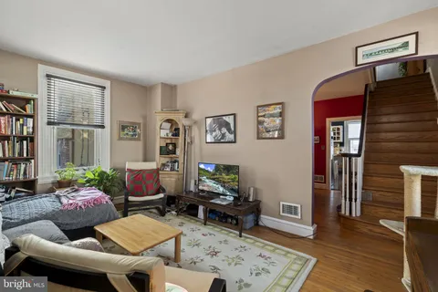 a living room with furniture and wooden floor
