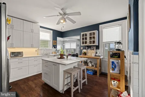 a kitchen with a stove a refrigerator and a sink